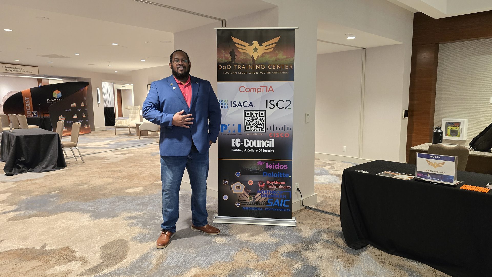 DoD Training Center team member at an industry conference booth