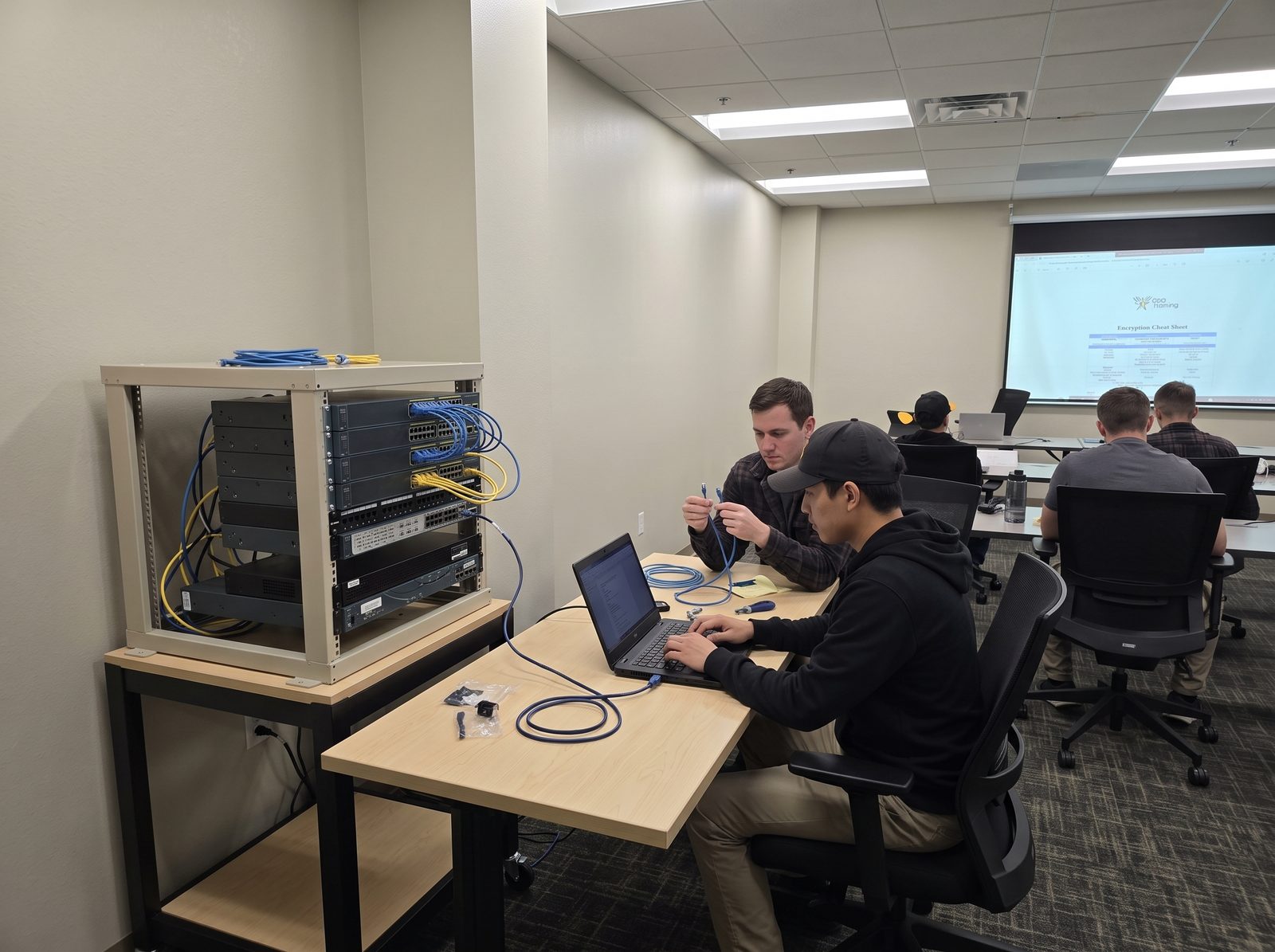 Student configuring a Cisco switch over a console cable during CCNA training