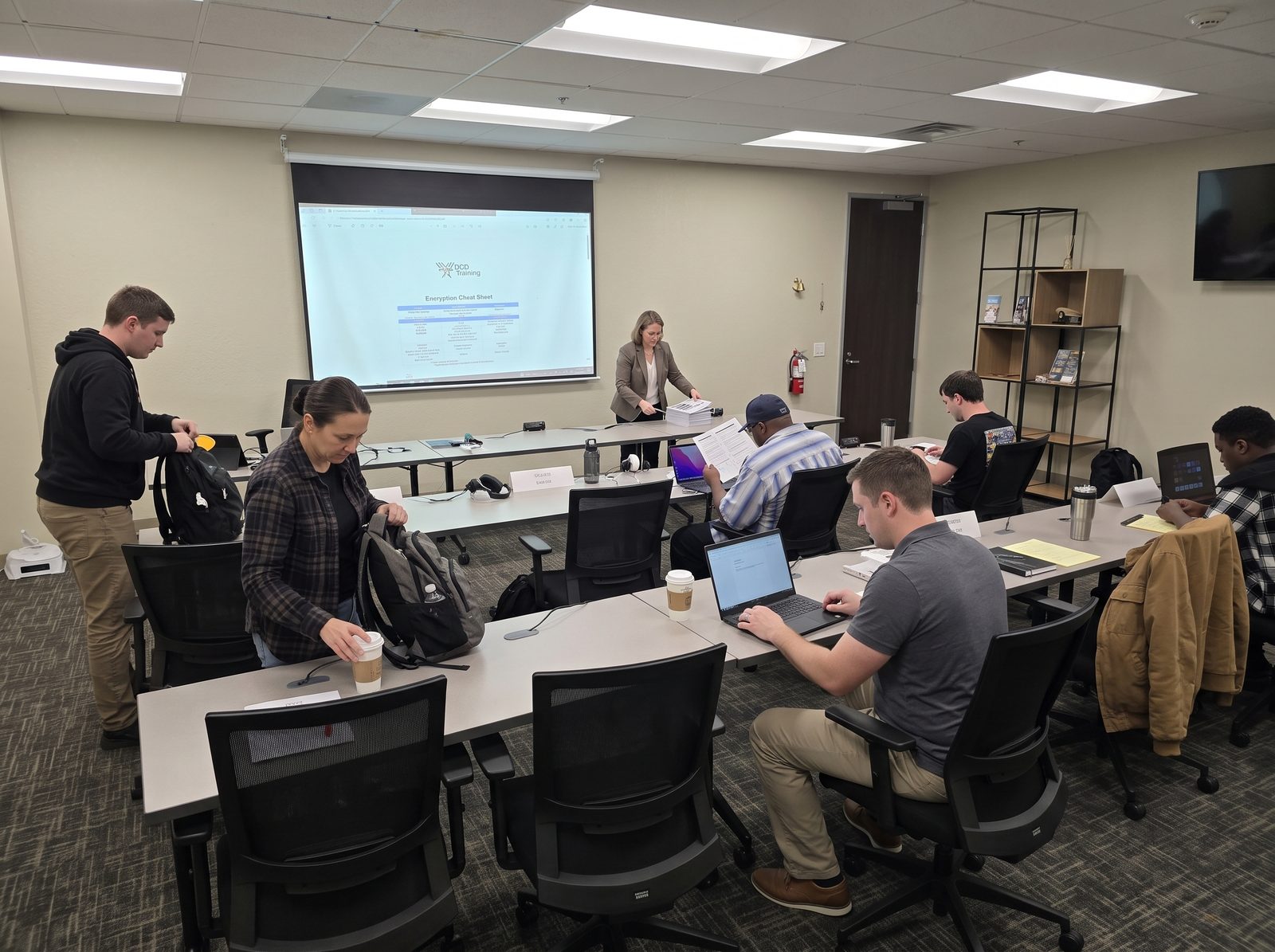 Students opening laptops on the first morning of a certification bootcamp in San Diego